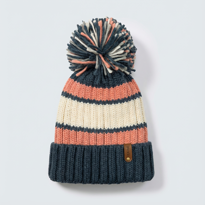 Knitted beanie with striped pattern and pom-pom on a light gray background