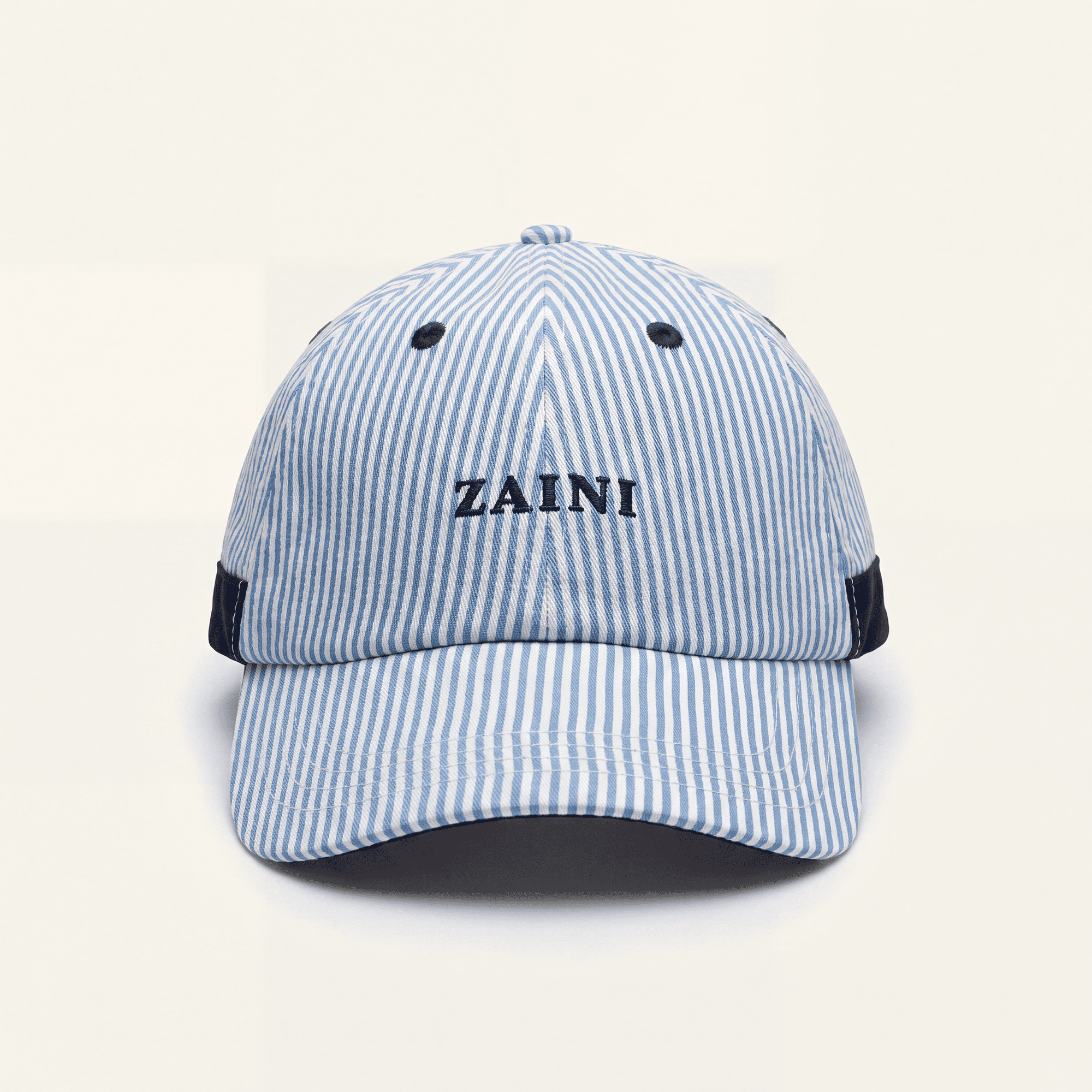 Blue and white striped cap with 'ZAINI' branding on a white background