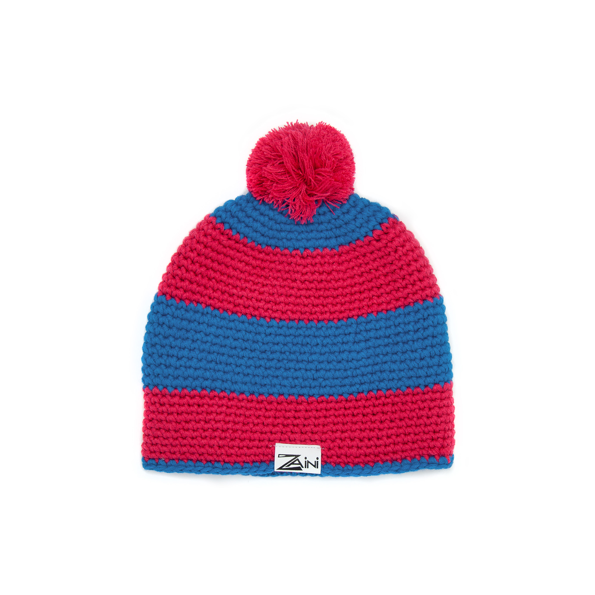 A striped kids' bobble hat in cherry red and blue, with a pink pom-pom on top, made from soft acrylic fabric.