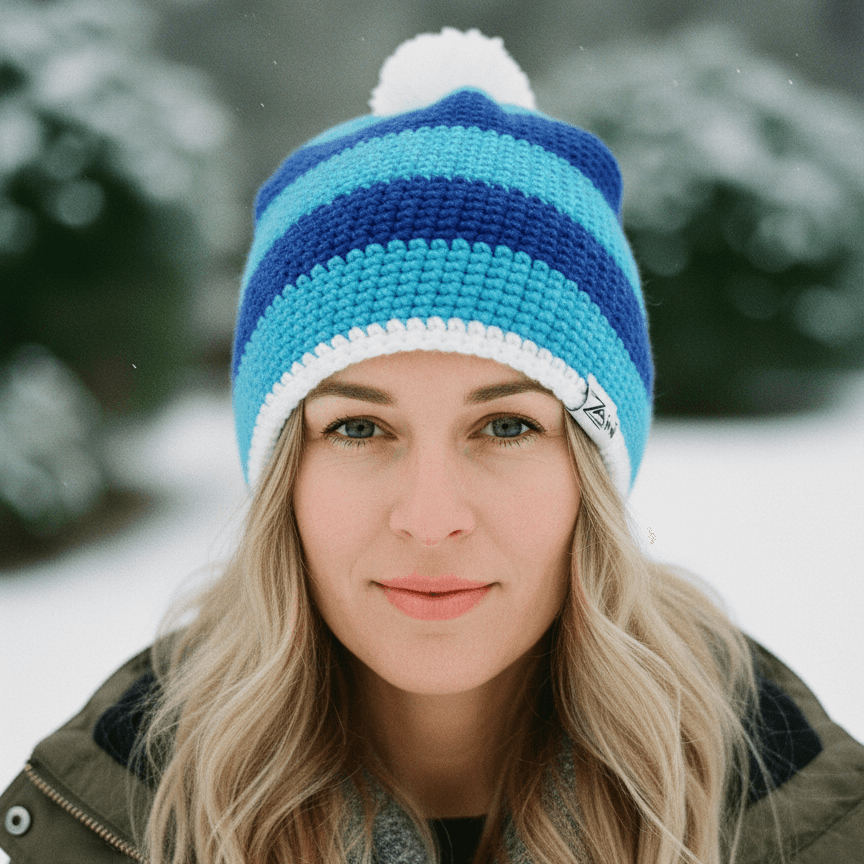 Woman wearing a blue and white striped beanie in a snowy outdoor setting