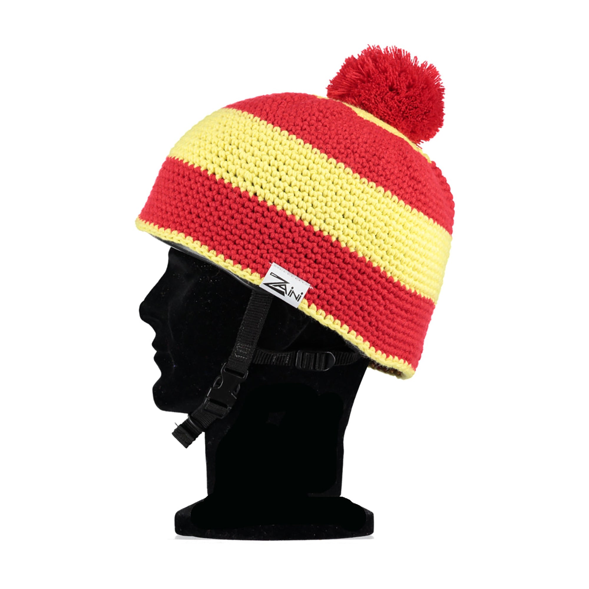 A striped red and yellow riding helmet cover with a pom-pom.