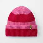 Two-tone pink and red beanie with a brand label on a white background