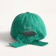 Green cap with a bow on a white background