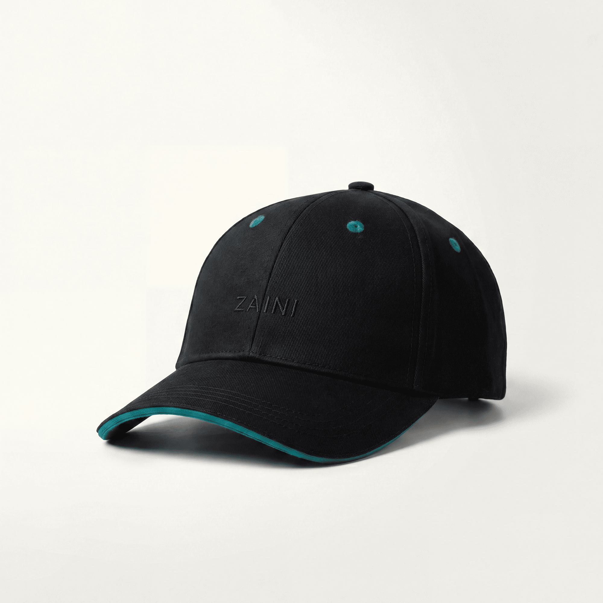 Black cap with teal rim and Zaini branding on a white background