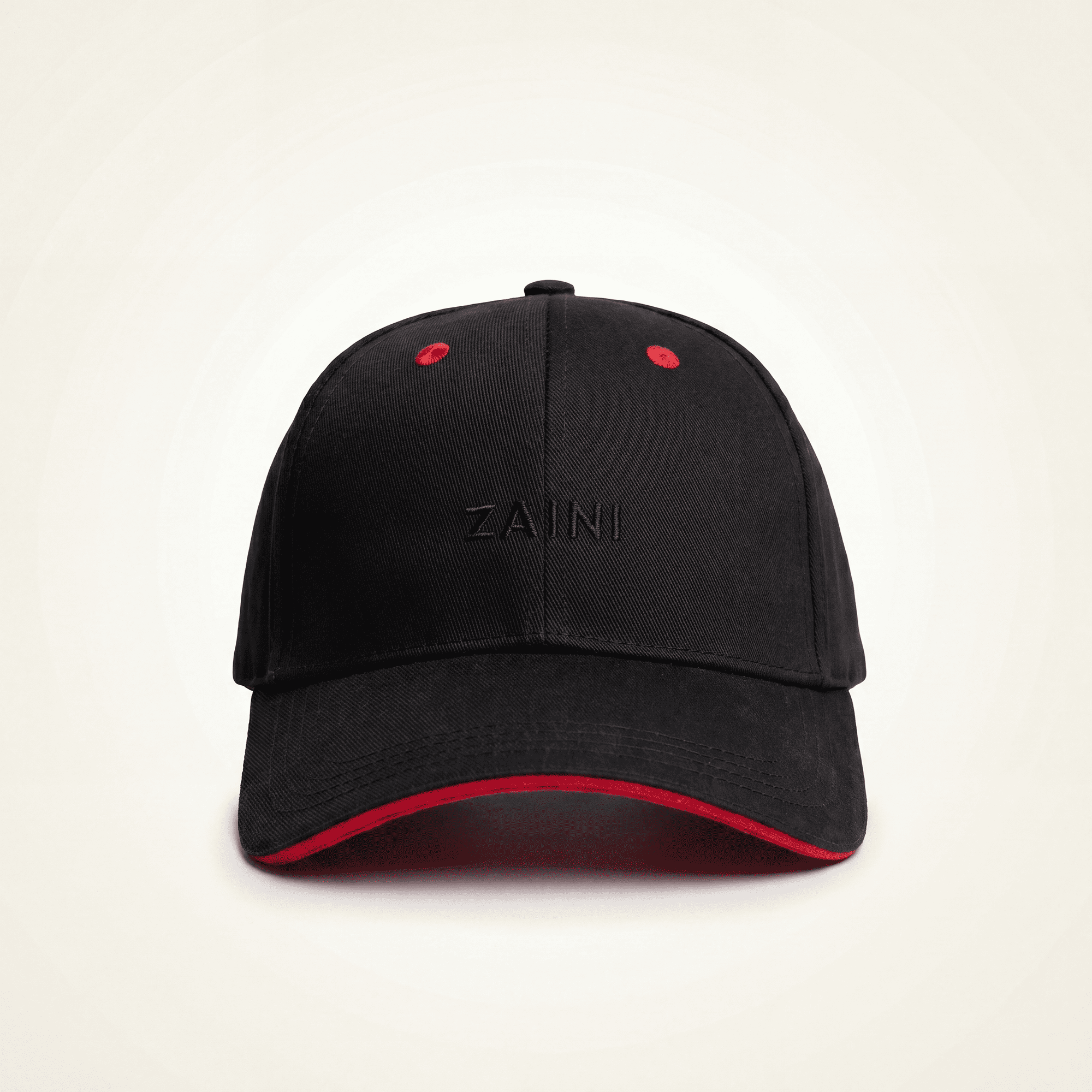 Black cap with red interior and rim on a beige background