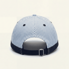 Blue and white striped baseball cap on a beige background