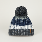 Knitted beanie with striped pattern and pom-pom on a light gray background