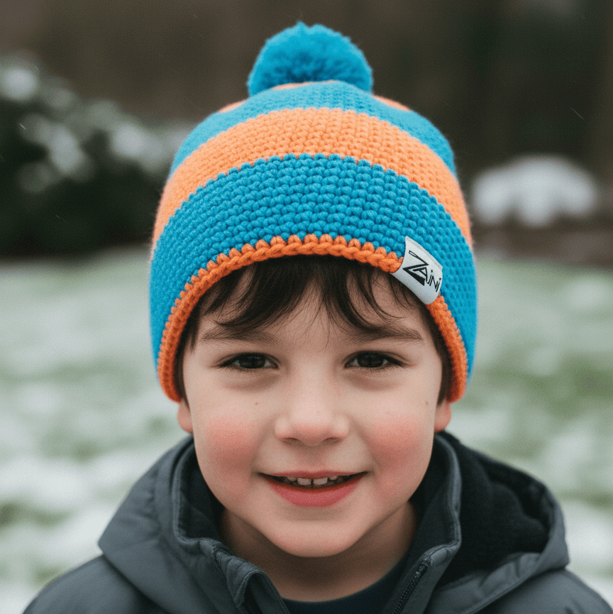 Child wearing a blue and orange knit hat with a blurred natural background