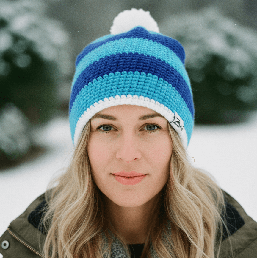 Woman wearing a blue and white striped beanie in a snowy outdoor setting